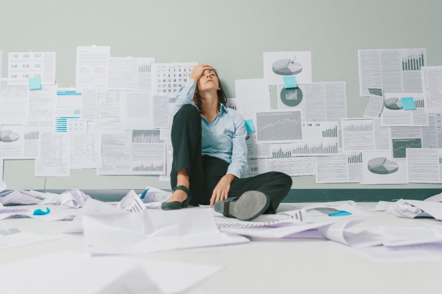 A Businesswoman Overwhelmed By Reports And Graphs From Trying To Diy Her Marketing.