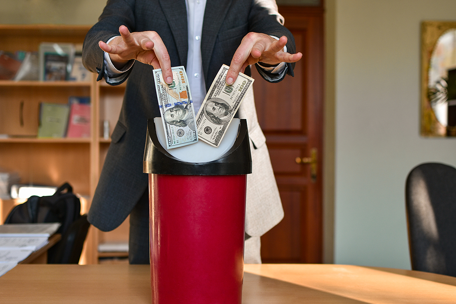 Office Manager In The Office Throws In Trash One Hundred Dollar Bills, Wasting Budget Concept.