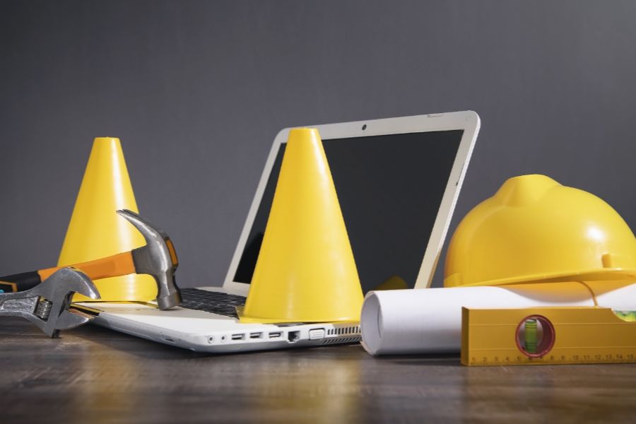 A Laptop Under Construction, Surrounded By Cones.